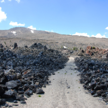 Cinder-Paved Road through the Glass Mountain Obsidian Flow, Glass Mountain in the left distance, Medicine Lake Volcano, Modoc National Forest, CA, 2012 Cinder-Paved Road through the Glass Mountain Obsidian Flow, Medicine Lake Volcano, CA, Vince Pitelka, 2012