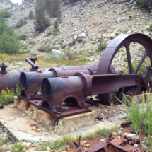 Large two-cylinder air-compressor, May Lundy Mine, Lake Canyon, Hoover Wilderness, CA, 2013. Behind is a large riveted air tank to store the compressed air. Mill Machinery, May Lundy Mine, Lake Canyon, Hoover Wilderness, CA, Vince Pitelka, 2013
