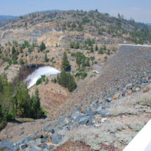HIgh-Pressure Outflow, Jackson Meadows Reservoir, CA, Middle Fork of the Yuba River, 2004, Henness Pass Road heading west in the far left. High-Pressure Outflow, Jackson Meadows Reservoir, CA, Vince Pitelka, 2004